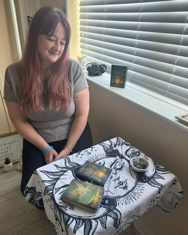Gemma giving a guidance card reading on a sun and moon cloth